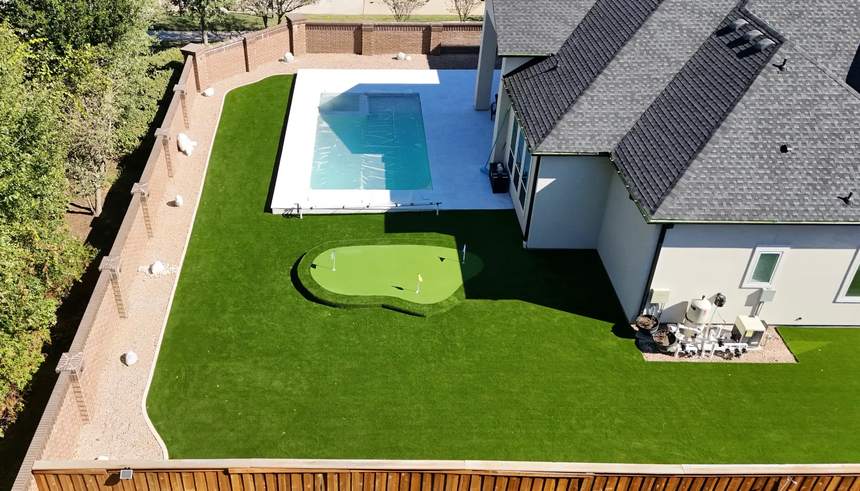 Aerial view of poolside turf and a custom putting green